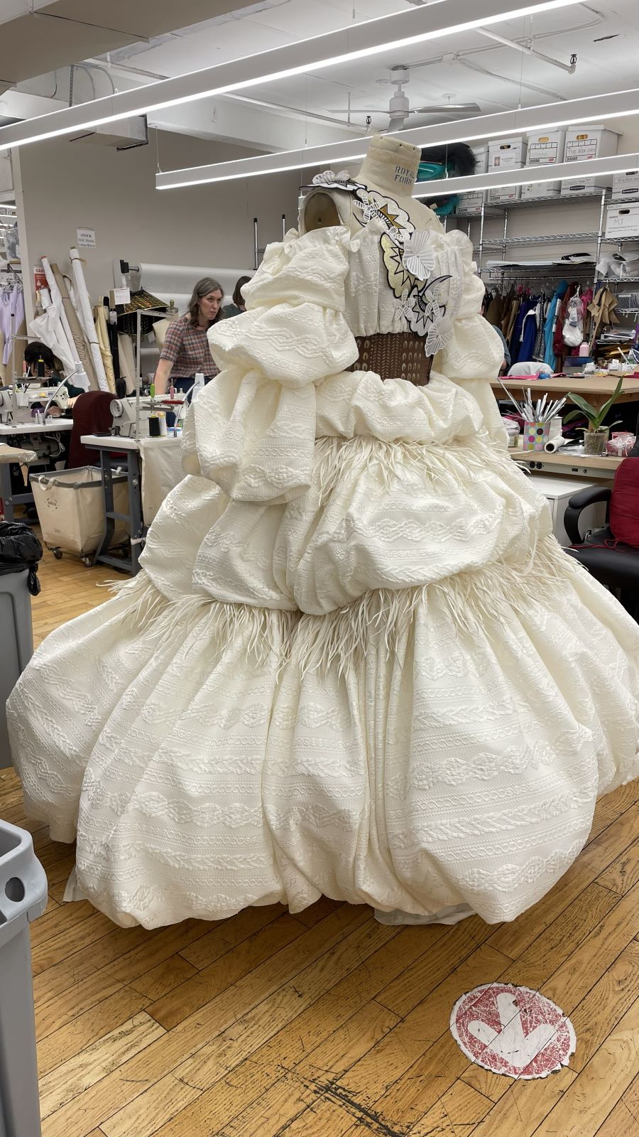 Full-volume ivory ball gown on the dress form