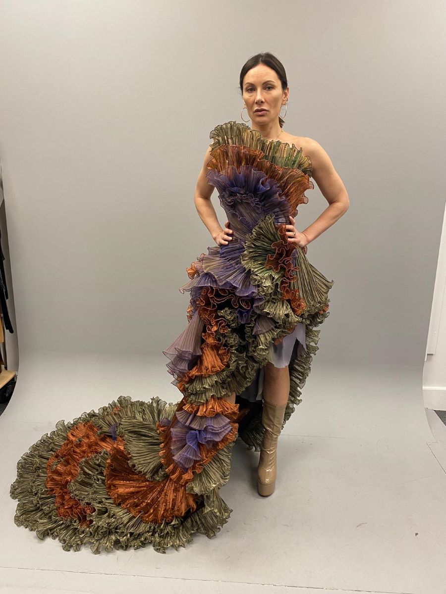 Ruffled evening gown fitted to the model