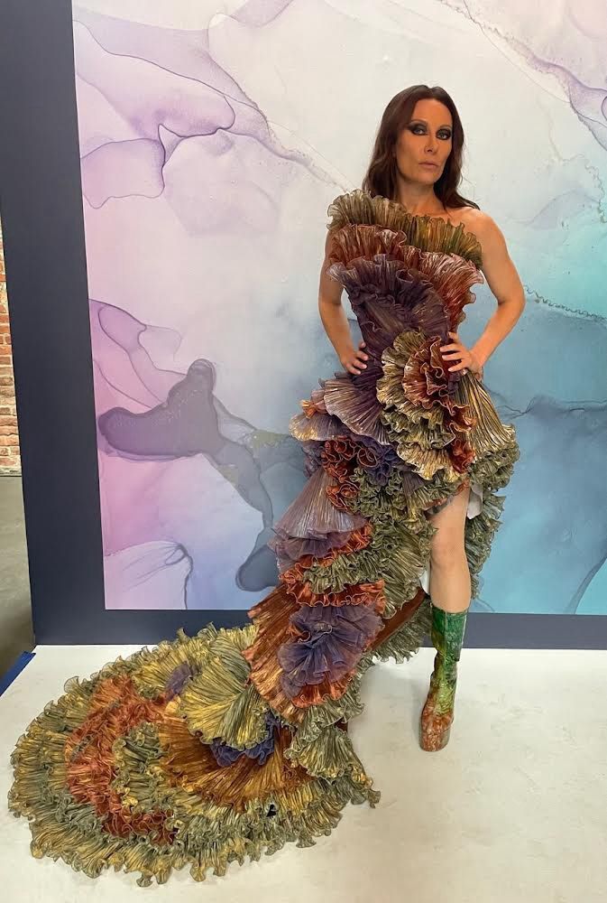 Ruffled evening gown photographed against colour