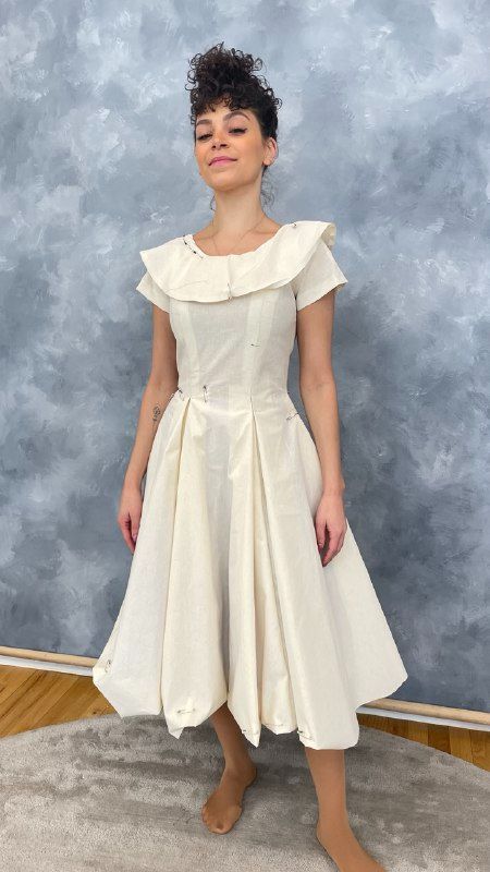 Ivory portrait-collar dress on the model